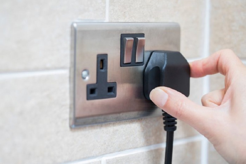 person plugging in a socket