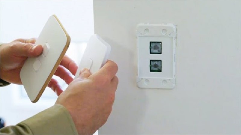 a person switching a switch in their home