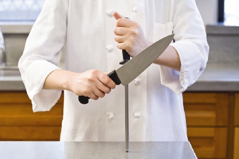person using knife sharpening